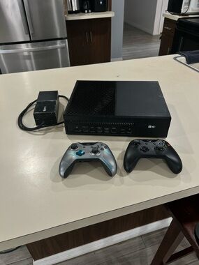 Microsoft Xbox One Console with Black and Silver Controllers